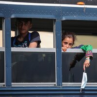 Afghan evacuees sit on a bus at the U.S. air base in Ramstein, Germany, on Aug. 26. Ramstein Air Base, the largest U.S. Air Force base in Europe, has hosted thousands of Afghans.